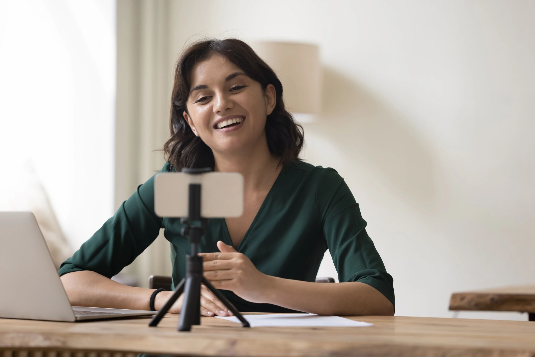 Cheerful pretty professional influencer woman shooting content for