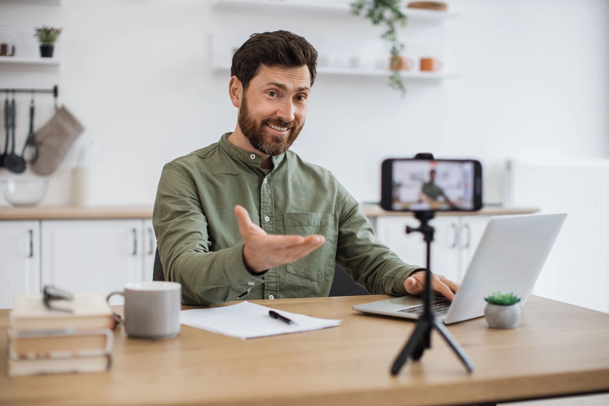 Confident bearded man sitting at desk and working
